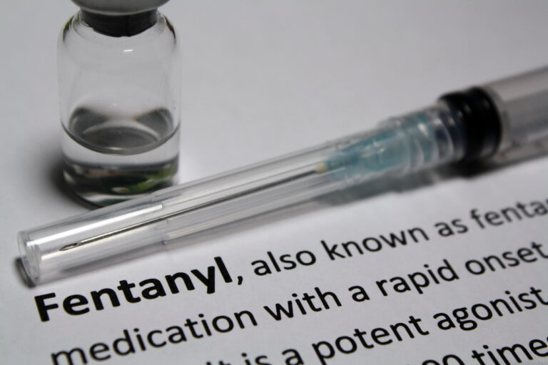 Description of fentanyl beside a syringe and a bottle, suggesting the new "fentanyl" law in Texas.