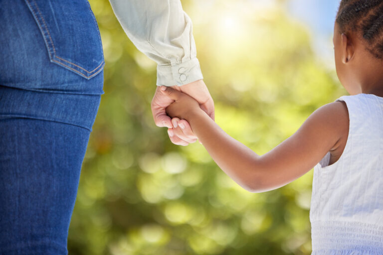 Woman holding a young girl's hand accused of solicitation of a minor in Texas.