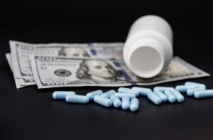 Blue fentanyl pills spilled on cash, symbolizing drug trade and criminal charges in Texas.