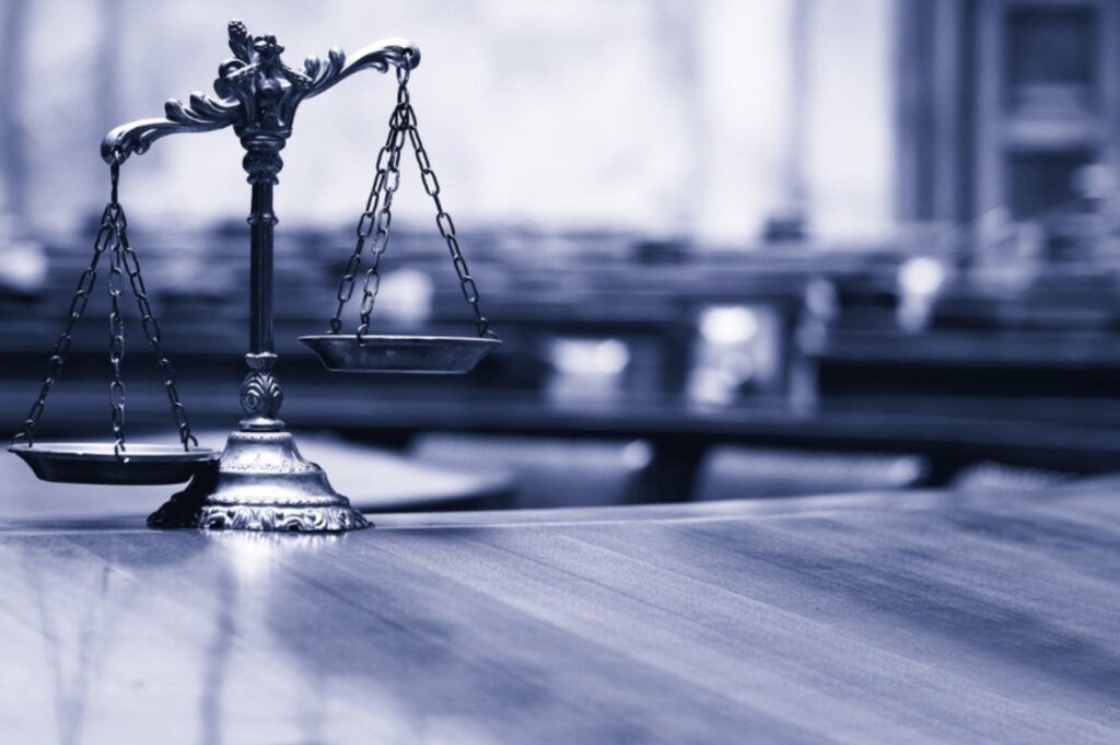 Scales of justice inside a courtroom, symbolizing Texas legal consequences for animal cruelty convictions.