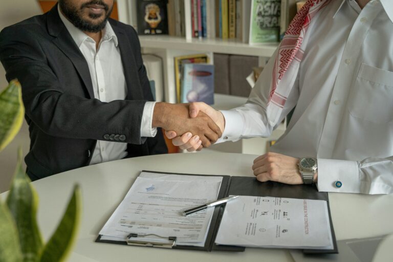 A person choosing between a bail bond contract and a law firm's business card.
