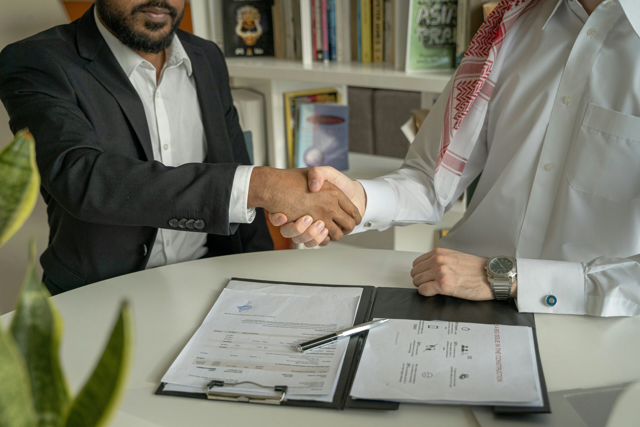 A person choosing between a bail bond contract and a law firm's business card.