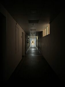 A long, dark prison corridor, symbolizing the finality of a 300-year prison sentence.