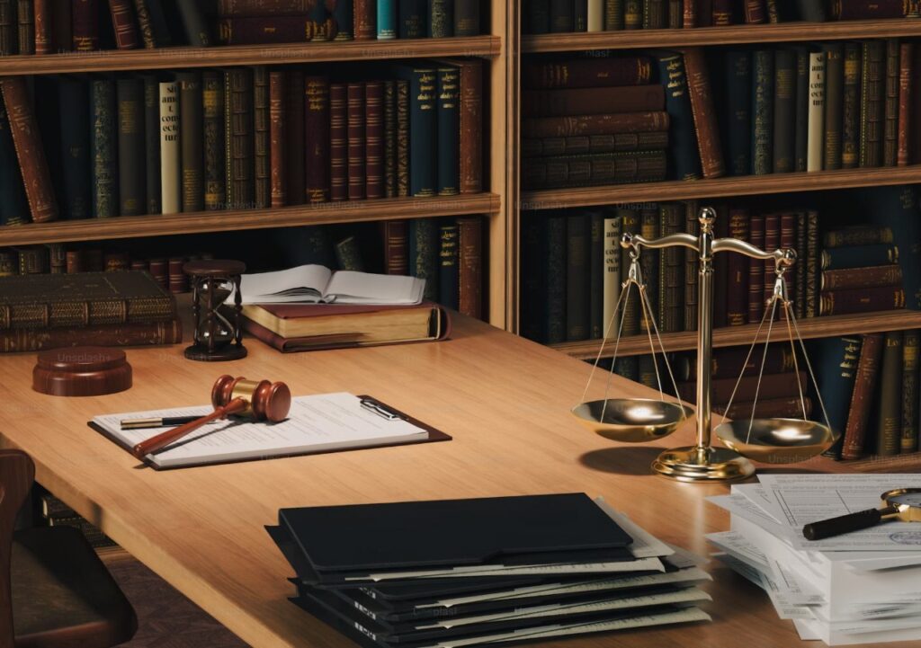 A pile of legal indictments and law books, representing the stacking of criminal charges.