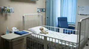 A hospital room with a child's bed, representing the medical setting where Munchausen by proxy occurs.